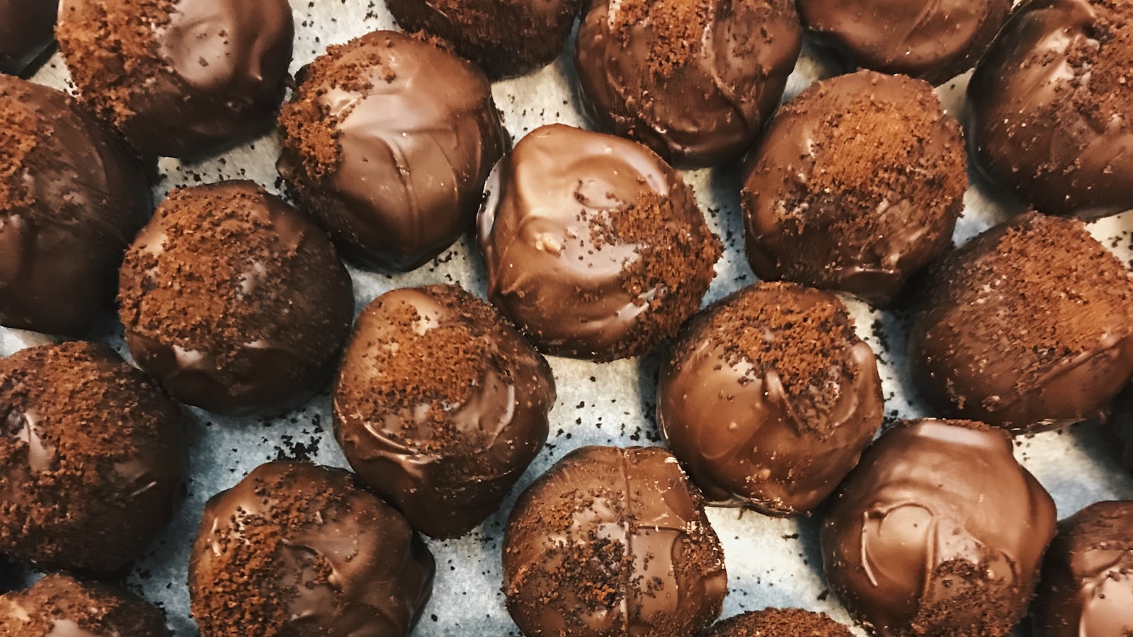 Fudgy brownies stacked on parchment