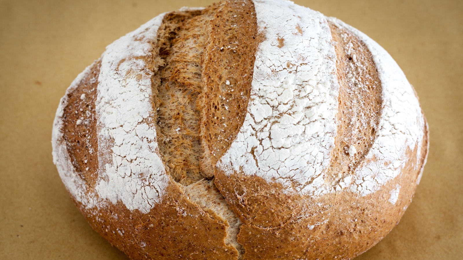 Two rustic loaves cooling on a rack